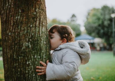 petite fille de 2, 3 ans embrassant, un arbre